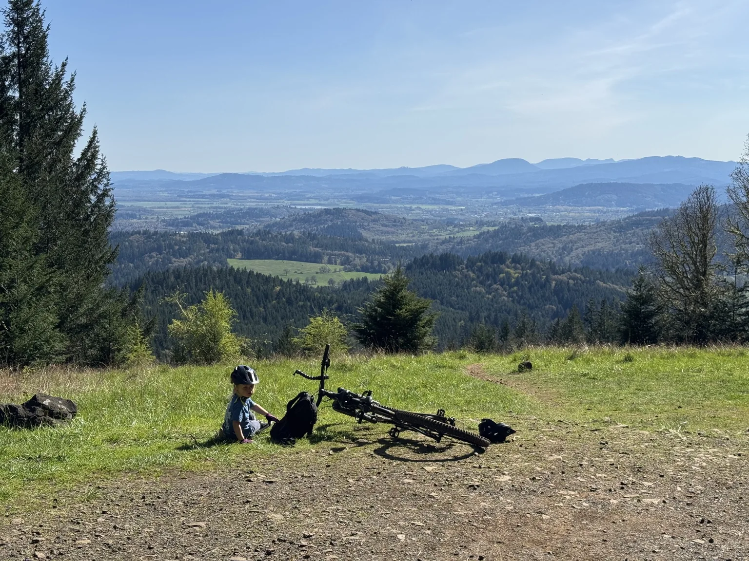 Young rider resting at a scenic overlook on Dimple Hill